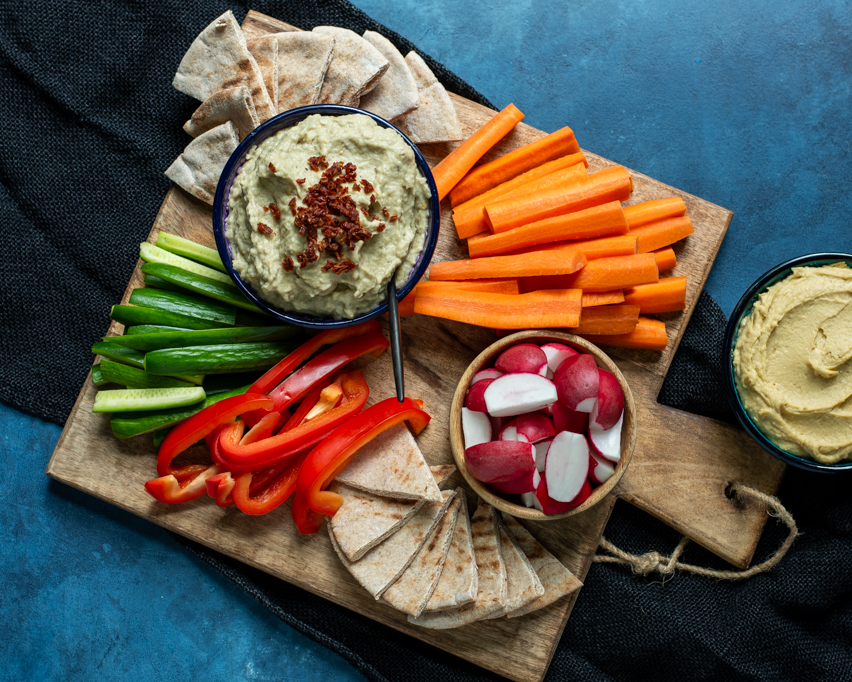 Baba Ganoush plated with raw veggies and toasted pita triangles