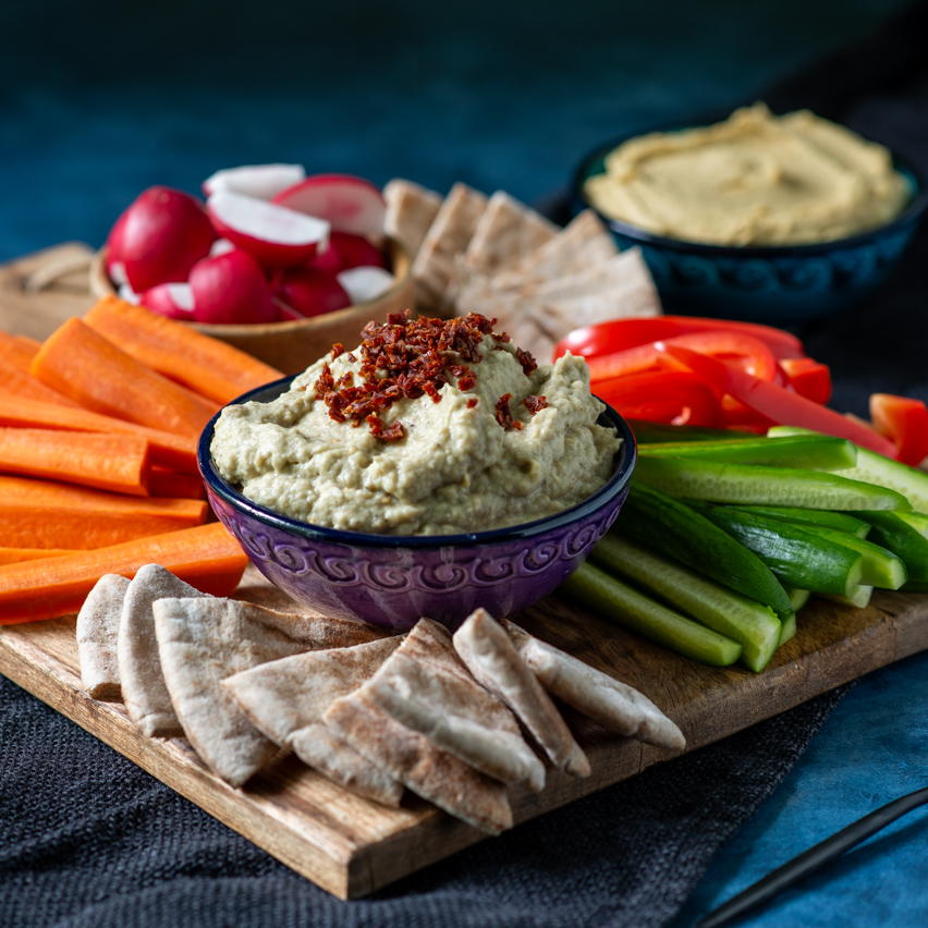 Baba Ganoush plated with raw veggies and toasted pita triangles